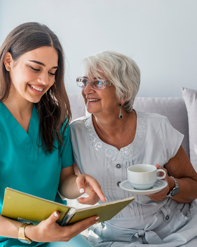 Supernal Companion Agency's Caregiver offering reading assistance, care and assistance to an elder